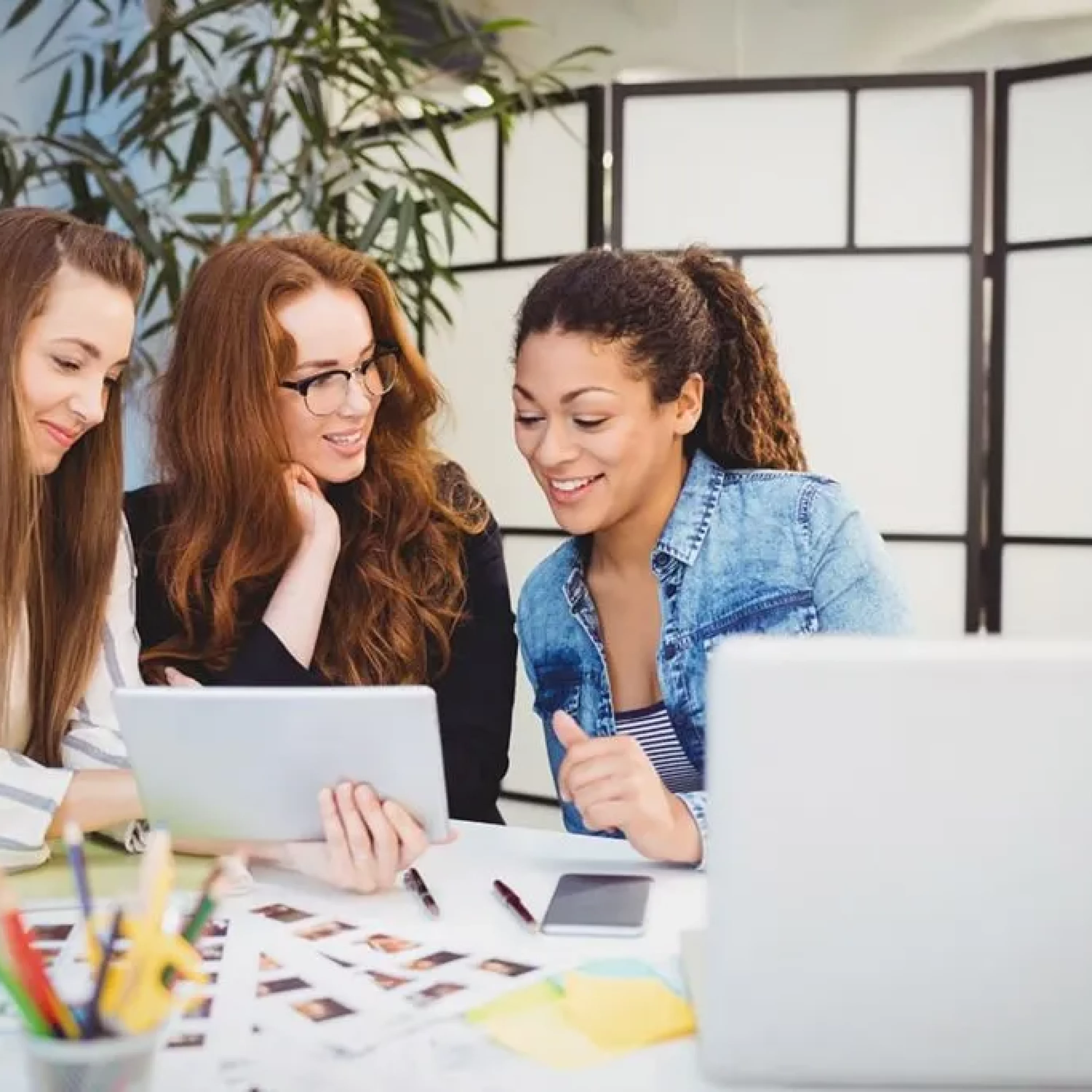 smiling-businesswomen-looking-at-digital-tablet-at-95VB2QG-1024x683